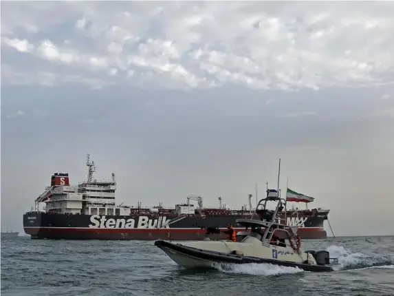  ?? (AFP/Getty) ?? Revolution­ary Guard patrol around a seized British-flagged ship