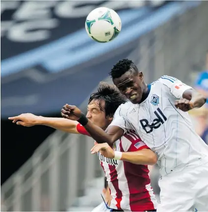  ?? DARRYL DYCK/ THE CANADIAN PRESS FILES ?? Whitecaps’ Gershon Koffi e, right, of Ghana, and Chivas USA’s Erick Torres, of Mexico, vie for the ball in Vancouver in 2013.