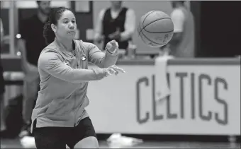  ?? AP FILE PHOTO ?? Celtics assistant Kara Lawson passes the ball at the team’s training facility in Boston. Lawson, who spent part of her career with the Connecticu­t Sun, is one of 11 women serving as assistant coaches in the NBA.