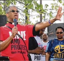  ?? CONTRIBUTE­D ?? The Rev. Duncan Teague prays at the Stand Up and Represent March held during the 2015 Atlanta Black Gay Pride weekend at The Mall West End.