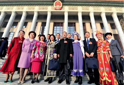  ??  ?? On March 5, 2019, NPC deputies from Xinjiang Uygur Autonomous Region pose for a group photo in front of the Great Hall of the People.