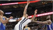  ?? BRANDON DILL — THE ASSOCIATED PRESS ?? Golden State Warriors’ Draymond Green, right, fouls Memphis Grizzlies’ Brandon Clarke, resulting in Green being ejected, in the first half during Game 1of a second-round NBA playoff series Sunday. The Warriors still won, 117-116.