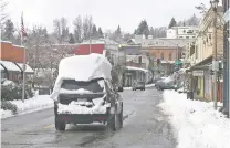  ?? ELIAS FUNEZ/THE UNION VIA AP ?? Snow is piled high on a motorist’s vehicle Tuesday in Grass Valley, Calif. Thousands were without power following the storm.