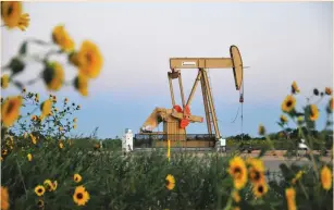  ?? (Nick Oxford/Reuters) ?? A PUMP jack operates at a well site leased by Devon Energy Production Company near Guthrie, Oklahoma.