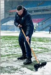  ?? ?? SNOW JOKE: Ground staff clear snow at Blackburn’s Ewood Park yesterday
