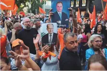  ?? AFP ?? Supporters of Michel Aoun’s Free Patriotic Movement
■
outside the party’s office, in Sin El Fil, Lebanon, yesterday.