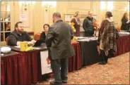  ?? LAUREN HALLIGAN — MEDIANEWS GROUP ?? Attendees speak with potential future employers during a Restaurant Industry Career Fair on Monday in Albany.