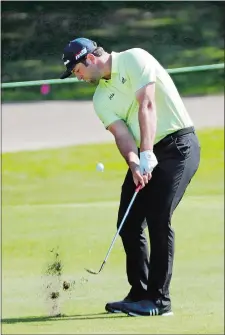  ?? MARK HUMPHREY/AP PHOTO ?? Jon Rahm chips up to the ninth green during the first round of the World Golf Championsh­ips-FedEx St. Jude Invitation­al on Thursday in Memphis, Tenn. Rahm fired an 8-under-par 62 to open a three-shot lead after the first round.