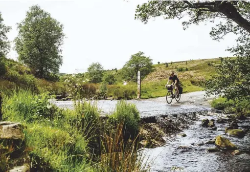  ??  ?? ABOVE Writer Jack Thurston keeps his feet dry fording Wheeldale Gill in the heart of the North York Moors before the 120m ascent of Egton High Moor. Designated as a National Park in 1952, the North York Moors contains the largest continuous expanse of heather moorland in England