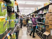  ?? KELSEY BRUNNER/THE ASPEN TIMES ?? Customers shop for cleaning products recently at an Aspen, Colorado, market as store employees restock shelves.