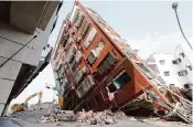  ?? ChiangYing-ying/Associated Press ?? Debris surrounds a building Thursday a day after a powerful earthquake struck in Hualien City, Taiwan.