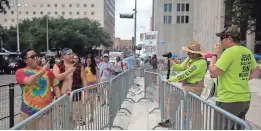  ?? SHELBY KNOWLES/NEWS21 ?? Marchers and protesters, cameras in hand, face off at the Houston Pride Parade in June.