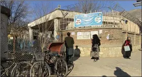  ?? ?? Afghan female university students stop by as Taliban security personnel stand next to the gate of Kabul University on Wednesday in Kabul, Afghanista­n.