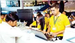  ?? SUPPLIED ?? Cambodia Securities Exchange staff get enquiries from the public.