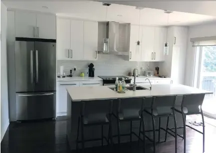  ?? PHOTOS: OTTAWA GENERAL CONTRACTOR­S ?? The completed kitchen features gorgeously balanced lights, darks and neutrals throughout. It is easily accessible by all family members and has become the family’s favourite room. “It’s more practical,” says homeowner Phyllis So.