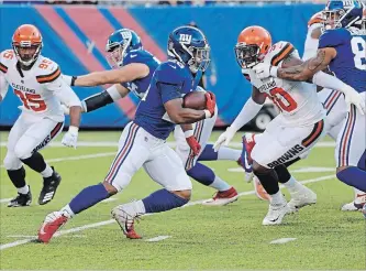  ?? BILL KOSTROUN
THE ASSOCIATED PRESS ?? New York Giants fans were excited to see rookie running back Saquon Barkley, centre, make an impressive run on his first touch but he was unremarkab­le the rest of the game against the Cleveland Browns this week.