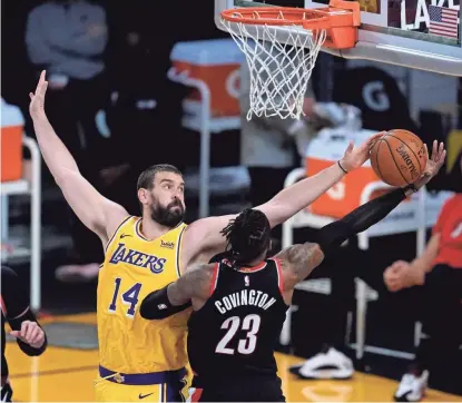  ?? ASHLEY LANDIS/AP ?? Los Angeles Lakers center Marc Gasol (14) blocks a shot by Portland Trail Blazers forward Robert Covington (23) during the third quarter of an NBA basketball game Monday in Los Angeles.
