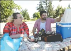  ?? BEA AHBECK/NEWS-SENTINEL ?? Dating couple Nelliemay Bickford and Kevin Mendoza, both of Stockton, enjoy the shade, some cold water and the breeze coming off Lodi Lake on Tuesday afternoon.The temperatur­e reached 94 degrees in Lodi.