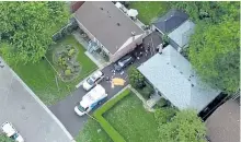  ?? PASCAL MARCHAND/THE CANADIAN PRESS ?? Police and paramedics stand in the driveway of a house in Scarboroug­h on Thursday, after three people were killed in a crossbow attack.