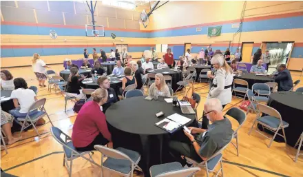  ?? DE SISTI/MILWAUKEE JOURNAL SENTINEL ?? Attendees of the Scaling Wellness in Milwaukee, or SWIM, strategy meeting gather in the Journey House gymnasium.