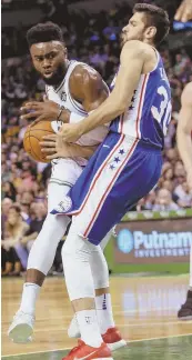  ?? STAFF PHOTO BY NICOLAUS CZARNECKI ?? COLLISION COURSE: Jaylen Brown bumps into the 76ers' Furkan Korkmaz as he tries to drive the lane during the Celtics' preseason victory last night at the Garden.