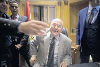  ??  ?? CONTENDER, READY: Presidenti­al candidate Moussa Mustafa Moussa of the Tomorrow party, smiles as he is surrounded by his aides at his office in Cairo.