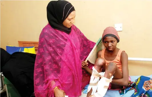  ?? PHOTO ?? Wife of Borno State governor, Nana Kashim Shettima, commiserat­ing with a victim of a recent bomb blast in Maiduguri, at the University of Maiduguri Teaching Hospital in Maiduguri on Tuesday. OMIRIN OLATUNJI