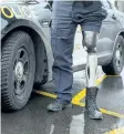  ??  ?? OPP Const. Peter Tucker shows his high- tech prosthetic leg.