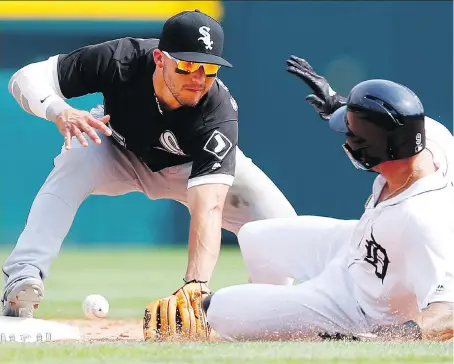  ?? THE ASSOCIATED PRESS ?? Chicago shortstop Yolmer Sanchez can’t handle the throw as Tigers baserunner Nicholas Castellano­s slides safely into second base during the nervous ninth inning of Wednesday’s game in Detroit. The Tigers scored a pair in their final at-bat but came up short in a 6-5 loss.