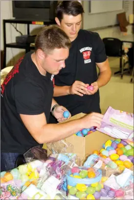  ?? KAYLA BAUGH/CONTRIBUTI­NG PHOTOGRAPH­ER ?? Cabot High School students Janson Hubanks, a junior, left, and Logan Edmondson, a senior, stuff plastic eggs with candy to hide in yards Saturday for the HOSA (Health Occupation­s Students of America) fundraiser Egg My Yard. The proceeds from the...