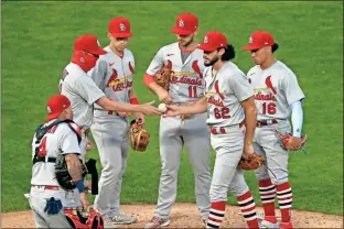  ?? AP - Jim Mone ?? Two Cardinals players tested positive for the coronaviru­s, leading Major League Baseball to Friday’s game in Milwaukee. call