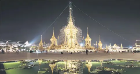  ?? — AFP photo ?? The cremation site for the late Bhumibol is reflected on a lotus pool.