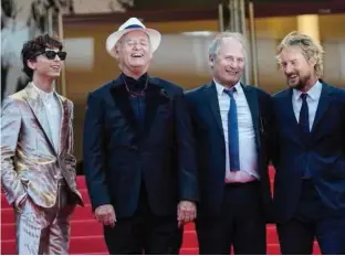  ??  ?? Timothee Chalamet (left), Bill Murray, Hippolyte Girard and Owen Wilson pose for photograph­ers upon arrival at the premiere of the film ‘The French Dispatch.’
