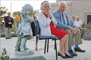  ?? Katharine Lotze/The Signal (See additional photos at signalscv.com) ?? Jacqulyn Petersen is overcome with emotion as she sits beside husband Harold Petersen after a newlydedic­ated children’s garden bearing their name is unveiled at the Child and Family Center on Tuesday.