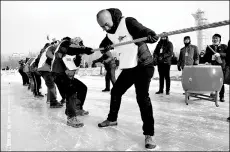  ?? PHOTOS PROVIDED TO CHINA DAILY ?? Left: One of Jiayuguan, Gansu province’s coolest attraction­s is packed with ice slides and snow games. Right: Yamzho Yumco (Sacred Swan) Lake in Tibet is surrounded by snow-capped mountains.