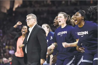  ?? Sean Rayford / Associated Press ?? UConn coach Geno Auriemma watches from the sideline while the bench celebrates a defensive play during the first half on Monday, in Columbia, S.C.