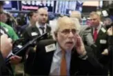  ?? RICHARD DREW — THE ASSOCIATED PRESS ?? Trader Peter Tuchman works on the floor of the New York Stock Exchange, Thursday. U.S. stocks skidded Thursday after Senate Republican­s surprised Wall Street by proposing a delay in cutting corporate taxes.