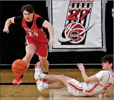  ?? CHRIS CHRISTO — BOSTON HERALD ?? Woburn, MA - February 18, 2024: Central Catholic’s Drew O’Keefe chases a loose ball by going over Catholic Memorial’s Graham Horowitz.