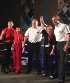  ??  ?? Kickboxer Nora Walsh has her hand raised after a great performanc­e in Larne.