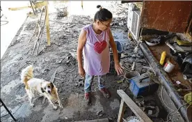  ?? JIM WYSS / MIAMI HERALD ?? Aurea Gonzalez, 62, inspects damage to her house in Media Luna, Puerto Rico, after Hurricane Maria hit.