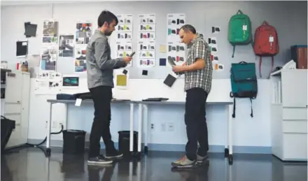  ??  ?? Thule Group CMF designer Dan Skaff, left, shows phone and tablet case designs to marketing director Jeff Warde at Case Logic in Niwot. At top, director Rebecca Taylor and Skaff compare color samples for a backpack design. Photos by AAron Ontiveroz, The...