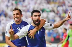  ??  ?? Al Hilal’s Omar Kharbin (right) celebrates with teammate after scoring a goal against Persepolis on Tuesday