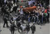  ?? MAYA LEVIN — THE ASSOCIATED PRESS FILE ?? Israeli police confront mourners as they carry the casket of slain Al Jazeera veteran journalist Shireen Abu Akleh during her funeral in east Jerusalem, Friday.