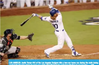  ??  ?? LOS ANGELES: Justin Turner #10 of the Los Angeles Dodgers hits a two-run home run during the sixth inning against the Houston Astros in game one of the 2017 World Series at Dodger Stadium in Los Angeles. — AFP