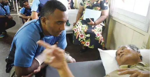  ?? Photo: Jone Luvenitoga ?? Serupepeli Vularika shares a moment with spinal injury rehabilita­tion patient Tiotin Tioti of Christmas Island during the Fiji Drua team visit on August 24, 2017.