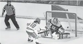  ?? UNIVERSITY OF WISCONSIN ?? Minnesota goaltender Sidney Peters deflects a shot by Wisconsin's Abby Roque on Saturday.