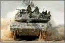  ?? PHOTO: REUTERS ?? Israeli tank outside the Gaza Strip