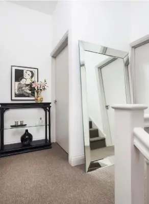  ??  ?? MAIN BEDROOMLyn­lea and Gareth converted the loft to create a bedroom with ensuite bathroom. The mirror is from Haviland Designs, with the edge of the frame painted in Little Greene’s Lead Colour. The wall is painted in Farrow &amp; Ball’s Cornforth White.For a similar lamp, try The White CompanyBAT­HROOMFloor space was limited, so the couple opted for a deep Japanese-style soaking tub from Omnitub LANDINGA vintage console table creates an elegant focal point. The woodcut print by Anita Klein was a present from Gareth’s mother when Lucas was born