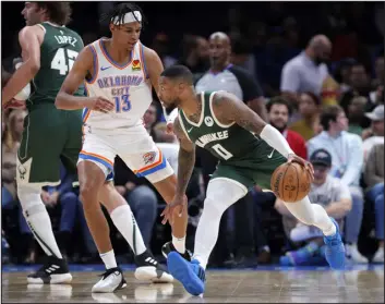  ?? SARAH PHIPPS — THE ASSOCIATED PRESS ?? Bucks guard Damian Lillard (0) tries to get past Thunder forward Ousmane Dieng (13) in the first half Tuesday in Oklahoma City.