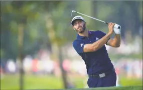  ?? Stuart Franklin / Getty Images ?? Dustin Johnson plays a shot on the 12th hole during the second round of the PGA Championsh­ip at Bellerive Country Club on Friday.